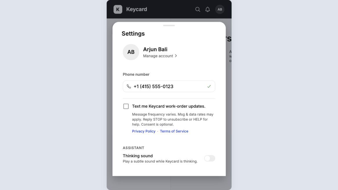 Keycard Settings screen showing a verified phone number and an unchecked optional checkbox for work-order text updates